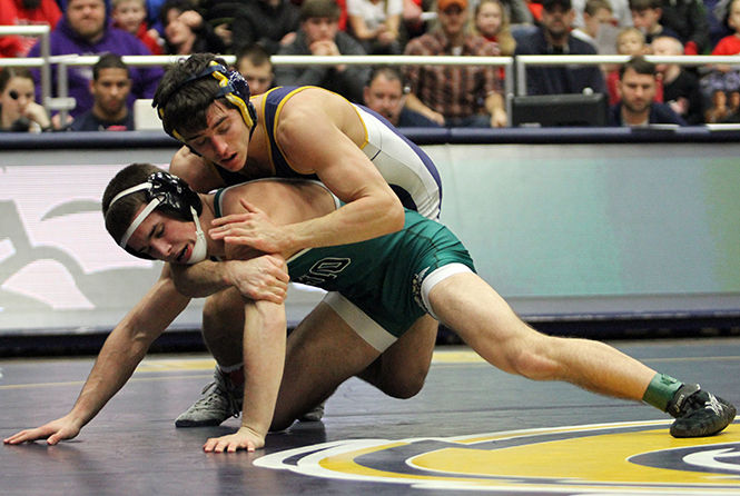 Kent State's Tyler Small tries to take down Ohio's Joel Shump during their wrestling meet in the M.A.C. Center on Friday, Jan. 16, 2015.