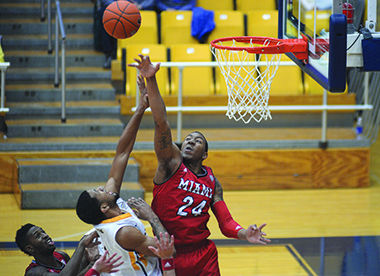 Kent State's Chris Ortiz attempts to make a basket but is blocked by the defense during the first half of the game against Miami University on Saturday, Feb. 7, 2014. Ortiz pulled the Flashes ahead during the last 43 seconds of the game with a dunk that brought the score 61-60 securing the win for Kent State.