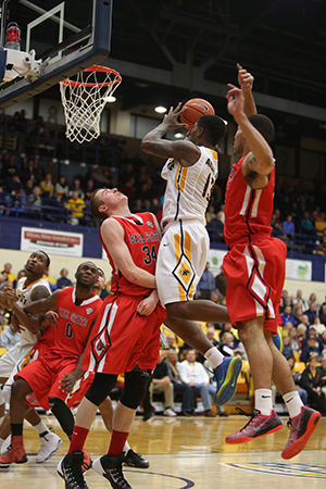 Kent State Forward junior Gary Akbar makes a layup against Ball State Michigan. Kent State defeated Ball State at the M.A.C. Center 58-53 on Wednesday, Feb. 18, 2015.