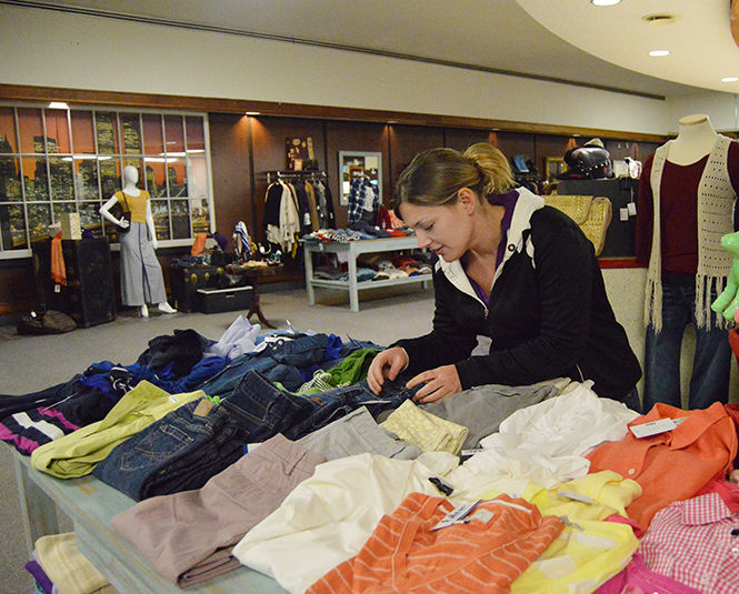 Shopper Lauren Johnson picks through the designer jeans at the new boutique in downtown Kent named “Blue” by Goodwill on Tuesday, Feb. 3, 2015. The boutique sells gently used clothing, furniture, and accessories that are name brand sold for thrifty prices.