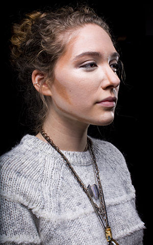 Senior fashion design major Libby Snyder in the process applying contouring make up to her face on Tuesday Feb. 2, 2015.