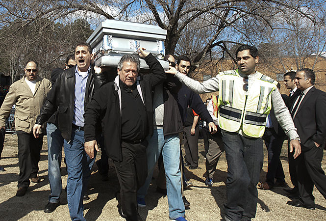 Caskets are carried into a public funeral for Deah Barakat, 23, his wife Yusor Abu-Salha, 21,and her sister, Razan Abu-Salha, 19 on Thursday, Feb. 12, 2015 at the Islamic Association of Raleigh's cemetery in Wendell, N.C. Barakat and his wife Yusor Mohammad Abu-Salha and her sister Razan Mohammad Abu-Salha were killed in a shooting Tuesday, Feb. 10, 2015 in Chapel Hill, N.C. (Corey Lewenstein/News &amp; Observer/TNS)