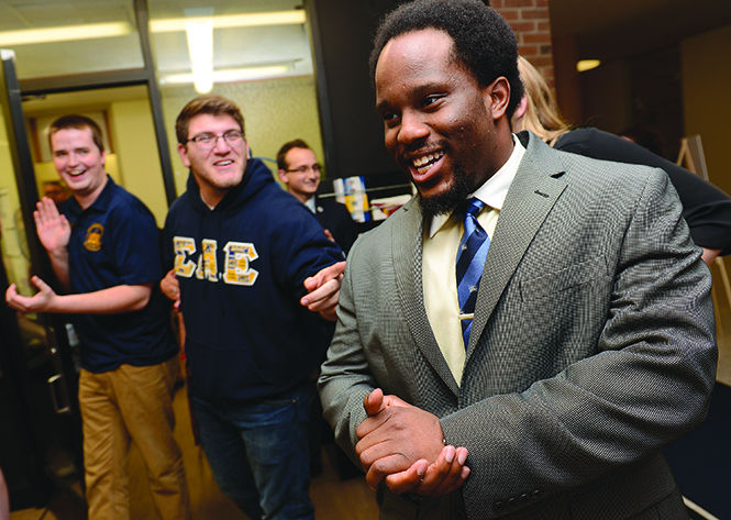 Junior entrepreneurship major Kevin Otubu reacts as he becomes the Director of Programming for Undergraduate Student Government as results of the elections are streamed in the Kent State Student Center, Tuesday, March 10, 2015.