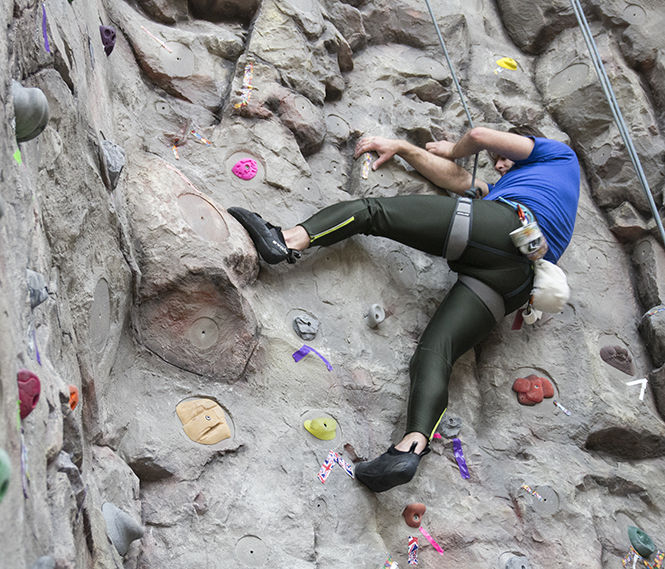 Verne Homscher, a graduate of The University of Akron, climbs the 35-foot rock climbing wall at the Rec Center on March 10, 2015.