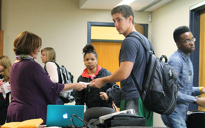 Cassandra Pegg-Kirby, assistant director for the Women's Center, educates students on the Green Dot Program and hands out informational pamphlets. "Doing something and doing nothing are both choices," she said Thursday, Oct. 29, 2014.