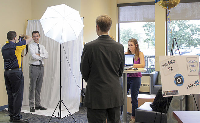   Matt Cowles, photographer for the College of Business photographs Shane Alesi, managerial marketing freshman at the LinkedIn photo booth during the COB business kick off event.