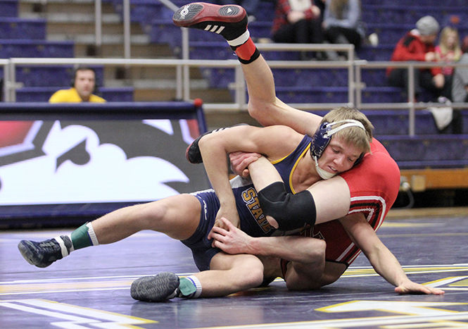 Junior Mack McGuire tries to escape the hold of Northern Illinois’ Jordan Northrup during their meet in the M.A.C. Center on Friday, Feb. 13, 2015.