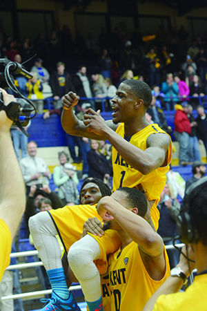 Kent State sophomore forward Marquiez Lawrence and senior guard Devareaux Manley carry senior guard Kris Brewer around the M.A.C. Center on their shoulders after he scored the game-winning layup with one second remaining against rival University of Akron, 79-77. With the win, Kent State guaranteed itself the No. 3 seed in the MAC Tournament and a share of the regular season title as MAC East Division champions.