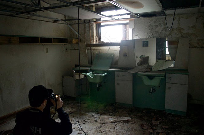 John Ponchak, a sophomore computer science major, pauses to take a photo at the Molly Stark Mental Institution.