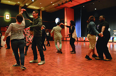 Friends dance together on April 1, 2015 at the Latin Festival held in the Kent State Ballroom. Friends got together to eat food and dance in celebration of their heritage.