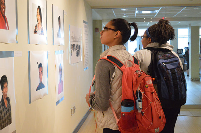 Human Development major Karlee Kimble and Justice Studies major Taraya Johnson observe the photographs in the Good Hair exhibit by Moema Furtado in Oscar Ritchie Hall on April 9, 2015. The “Good” Hair exhibit celebrates the beauty and diversity of black hair.