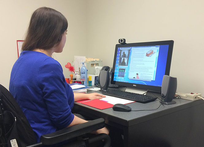 Lauren Ledzianowski, a Speech Pathology graduate student, conducts a thearpy session using the telepractice system from her computer.