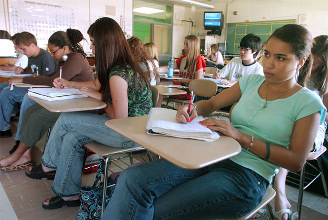 Diamond Outerbridge, 16, right, takes notes on gas laws in chemistry class taught by Kevin Henson at Lenape High School in Medford, New Jersey. (Sarah J. Glover/Philadelphia Inquirer/KRT)