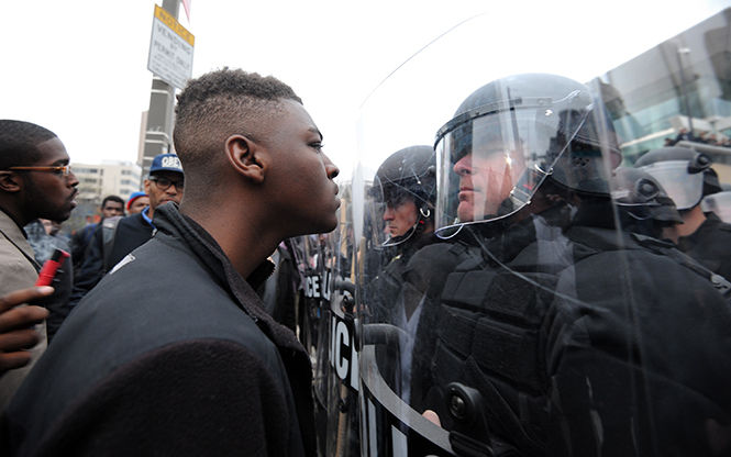 Police and protestors line up against each other across from Camden Yards in Baltimore on Saturday, April 25, 2015, as protests continue in the wake of Freddie Gray's death while in police custody. (Algerina Perna/Baltimore Sun/TNS)