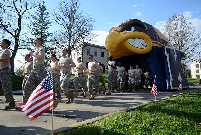 ROTC cadets approach the finish line at The WhiteHot 5K race across the Kent State campus that honors former fallen ROTC soldier Ashley White-Stumpf, who was killed in Afghanistan in October of 2011. The money raised from the race goes into a scholarship fund bearing White-Stumpf's name that benefits ROTC Cadets at Kent.