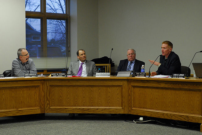 Kent City Manager David Ruller answers a question his colleague Melissa Long asks during the discussion of options for City Hall's two-year, temporary relocation at the city council meeting on Wednesday, April 1, 2015.