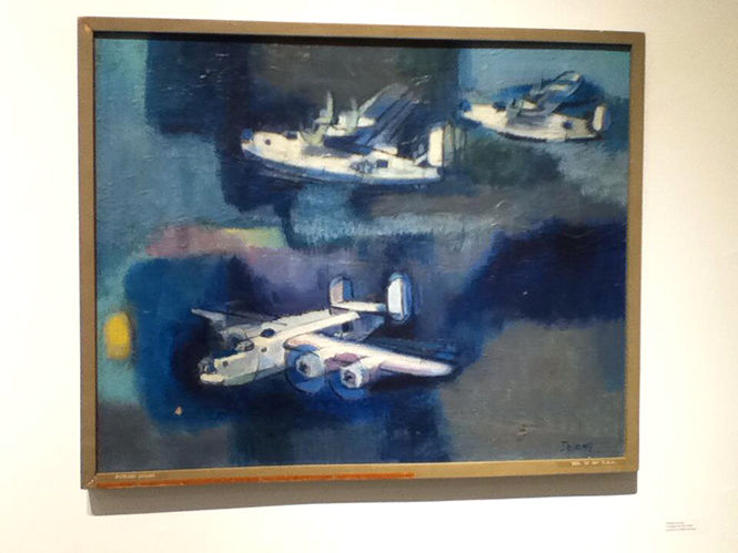  "Freedom and the Artist" by Patrick DeLong depicts World War II cargo planes. The painting belongs to the school's permanent collection.