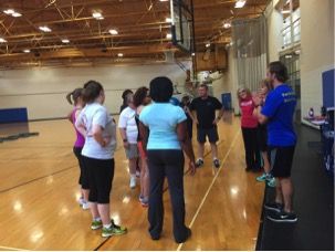 Graduate student and personal trainer Curt Fennell helps Fit for Life participants get organized to begin the exercise workshop on Wednesday, June 17, 2015.