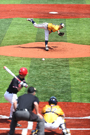 Sophomore Pitcher Andy Ravel pitching a ball against a Ball State University batter. The Flashes won 11 to 7. April 12, 2015.