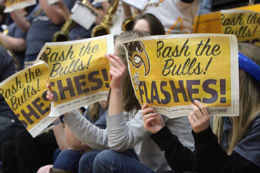 Fans hold up a Kent Stater issue which reads, "Bash the Bulls! Go Flashes!" at the Kent State men's basketball game on Saturday, Feb. 28, 2015.