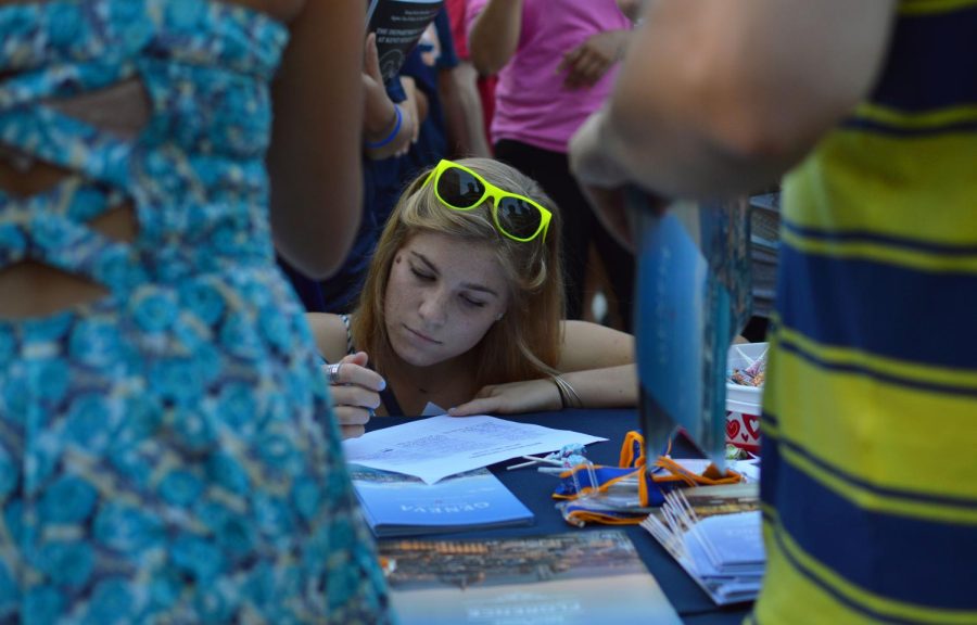 Freshman entrepreneurship major Jaynanne Sheehan signs up for information from the Office of Global Education during BlastOff 2015 on Aug. 30, 2015.