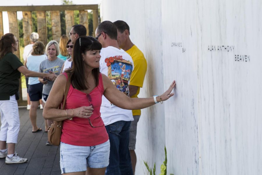 Brenda Vignault, a visitor to the Flight 93 crash sight, touches the Wall of Names, a feature at the Memorial that has the names of each of the victims of the crash. Sept. 9, 2015.