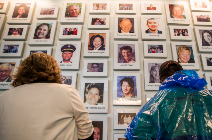 Two visitors to the Visitor Center Complex at the Flight 93 National Memorial look at a wall with the pictures of the 40 victims of the crash. The center opened to the public Sept. 10, 2015.