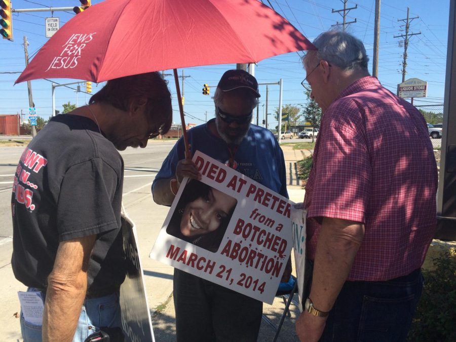 Anti-abortion activists from the Viewers of the Word Church protest outside Planned Parenthood's Bedford Heights Health Center, which performs abortions. House Bill 294 could lead to the reproductive health organization from no longer receiving government funding for breast and cervical cancer screenings, among other services.