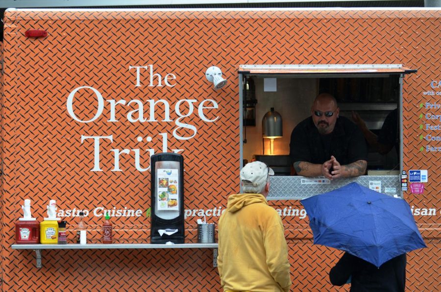 Steve Sabo, of The Orange Trük, talks to Dan and Donna Lange at the International Festival in Downtown Kent on Saturday Sept. 12, 2015.