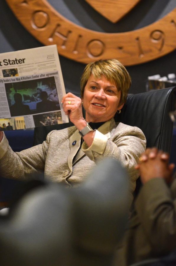 President Beverly Warren holds up a copy of The Kent Stater in the George Urban Board of Trustees Conference Room on Wednesday, Sept. 9, 2015. She told the board about the signing of an agreement with Vietnam’s Hanoi University for a partnership that happened on Tuesday, Sept. 9, 2015.