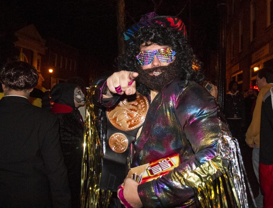 “Macho Man” Randy Savage offers fellow Halloween revelers to snap into a Slim Jim during Halloween in downtown Kent on Oct. 31, 2015.