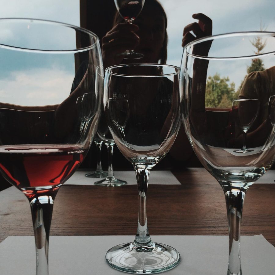 Jenna Watson, senior photojournalism major, inspects her wine for oxidation for the Wineries of Northeast Ohio class at Silver Run Vineyard and Winery in Norton, Ohio during fall semester 2015.