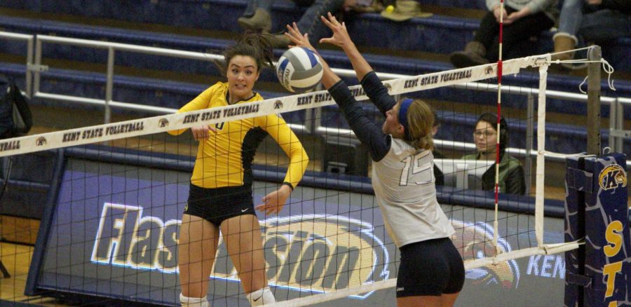 Freshman Lexi Mantas spikes the ball past a Toledo defender during the Kent State vs Toledo volleyball game on Oct. 16, 2015.