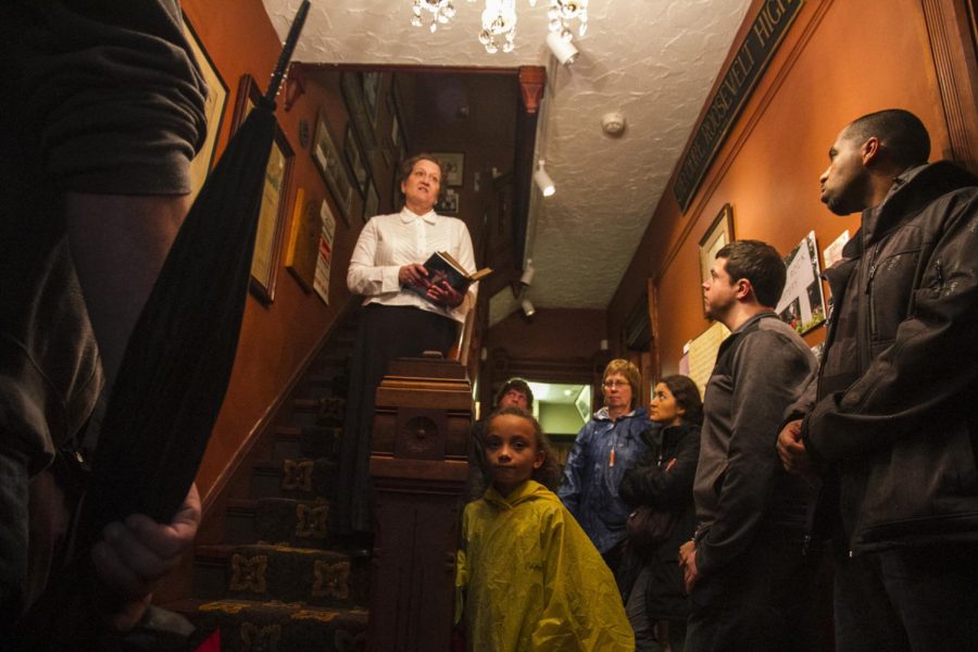 International students listen to ghost stories told by Kasha Legeza from the Kent Historical Society as part of the Kent Stage’s annual Ghost Walk on Oct. 24, 2015.