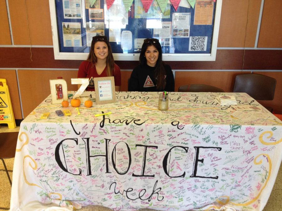 Anhelica Rodriguez, a junior fashion merchandising major, and Stephanie Martoccia, a sophomore public relations major and sister of Delta Zeta, sit in the Student Center asking people to take the no drinking and driving pledge. 