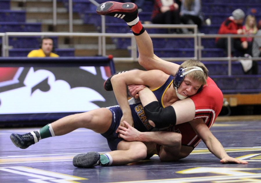 Mack McGuire tries to escape the hold of Northern Illinois’ Jordan Northrup during their meet in the M.A.C. Center on Friday, Feb. 13, 2015.