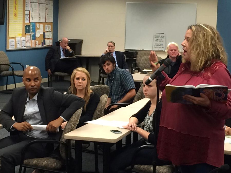 Mary Mural-Sizemore, whose son owns Porter's Taxi, voices her concerns with Uber at the Kent City Council meeting on Wednesday, Oct. 7, 2015. Delon White, Uber's general manager of Northeast Ohio, sits on the left.