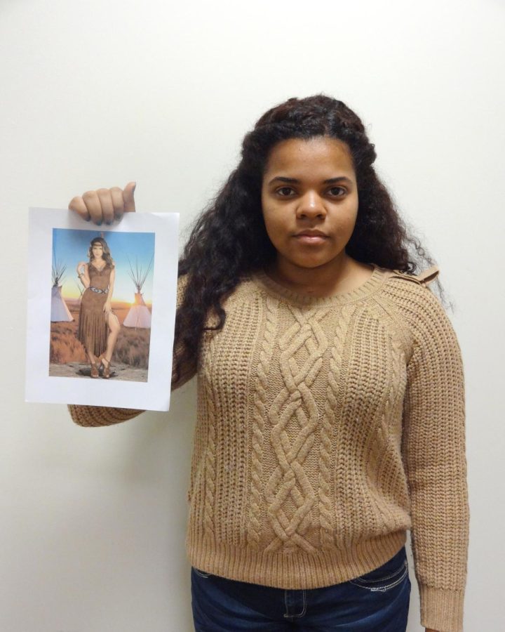 President of the Native American Student Association, Chelsea Ford, holds up a picture of a “Native American" costume. 