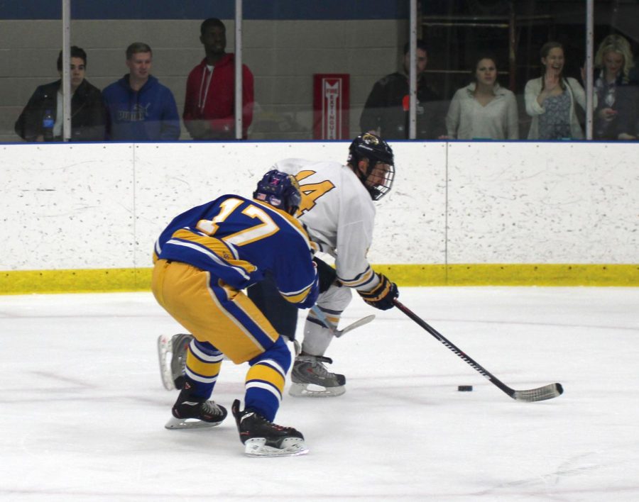 Kent State forward, Jon Buttitta, #14, defends the puck during their 3-2 victory over the University of Pittsburgh Friday, Nov. 6, 2015.