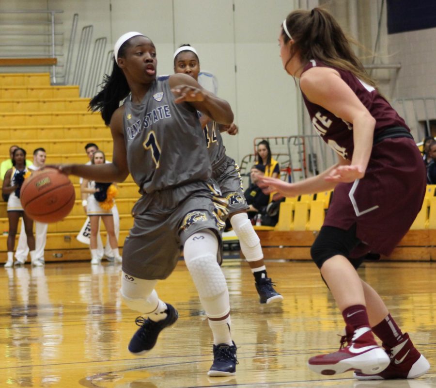 Sophomore gaurd Naddiyah Cross protects the ball from a player on Colgate University's team during the women's basketball game at the MACC. The Flashes won the game 76-71. Nov. 15, 2015.