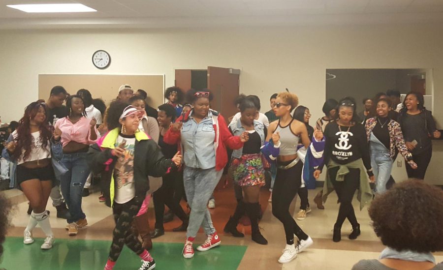 Students line-dance at BUS's "90s vs. 2000s" community dinner in the Oscar Ritchie Multipurpose Room on Monday, Nov. 9, 2015.