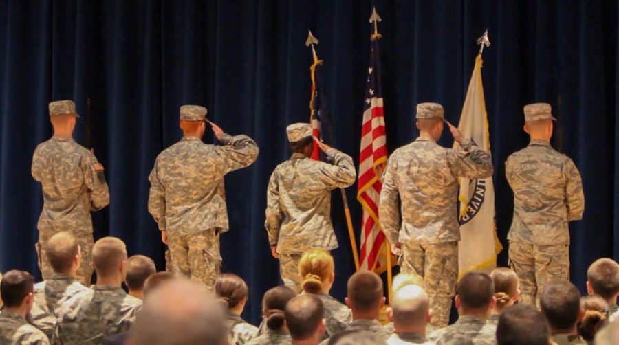 Members of the Kent State ROTC program stand at attention and salute the flags while the national anthem is played at the Veterans Day Memorial ceremony Tuesday, Nov. 10, 2015.