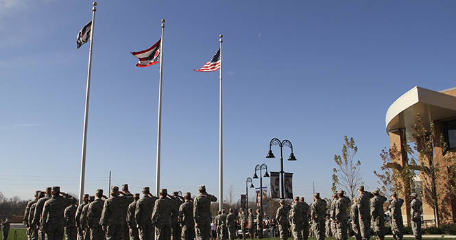 Kent State Army and Air Force ROTC students salute the raising of the United States, Ohio and POW/MIA flags during the annual KSU Veteran's Day observance ceremony held Wednesday, Nov. 7 at Risman Plaza. Photo by Shane Flanigan.