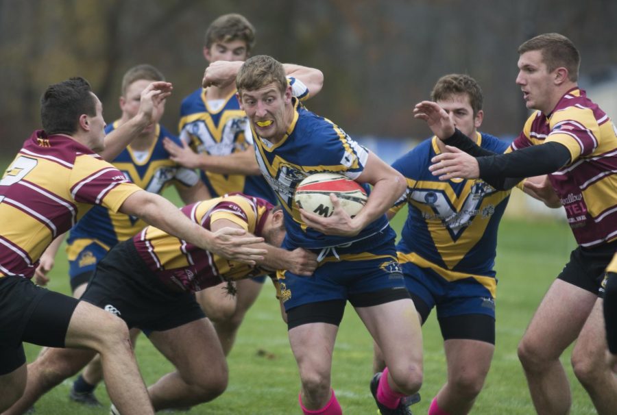 Kent State's Casey Smith tries to break through several Central Michigan defenders during the last Kent State Mens Rugby home game of the season on Saturday, October 31, 2015. Kent State fought hard to tie the match in the second half, but let in two late tries to lose 28-14.