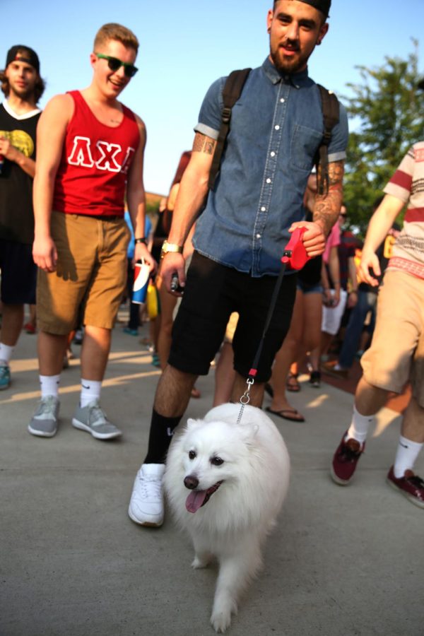 Sophomore Criminal Justice Major Christian Rubeis walks his dog, Rosie, down the Esplanade during Blast Off. Aug. 30, 2015.