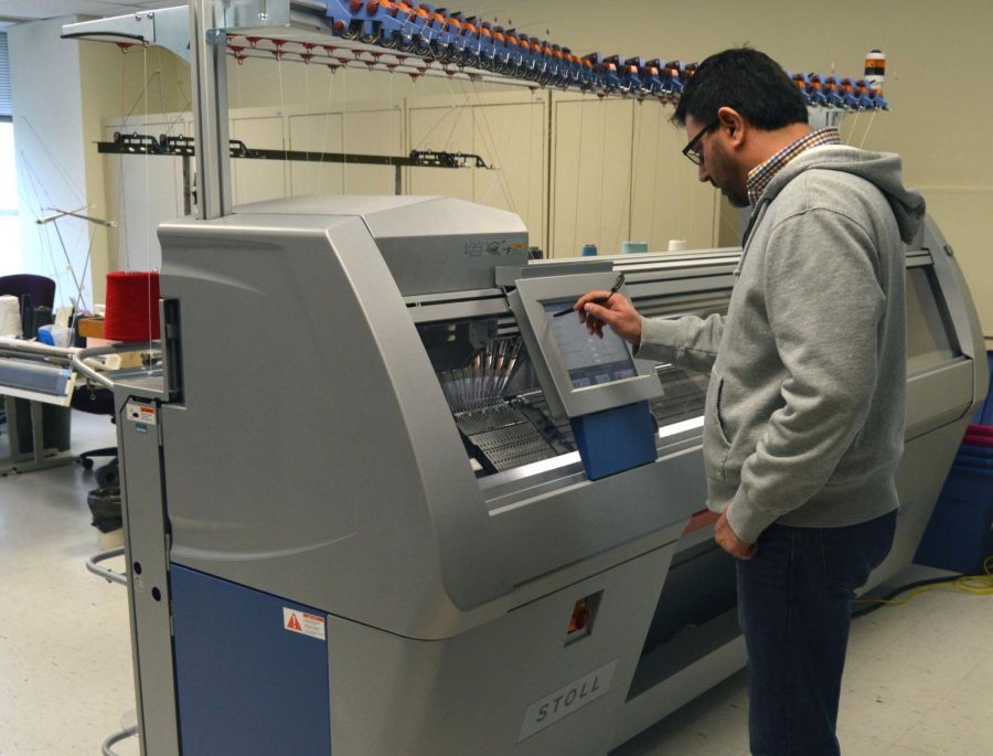 James Ahmad, the IT analyst, starts up the Stoll machine in the Fashion School to produce a basic pattern black and white scarf on Wednesday, Dec. 2, 2015. 