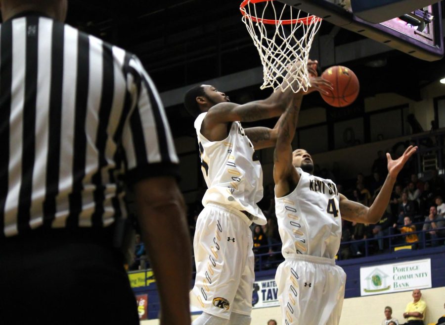 Senior center Khaliq Spicer (left) and senior forward Chris Ortiz (right) both jump high to make a basket in the game against the Marist Red Foxes on Saturday, November 21, 2015.