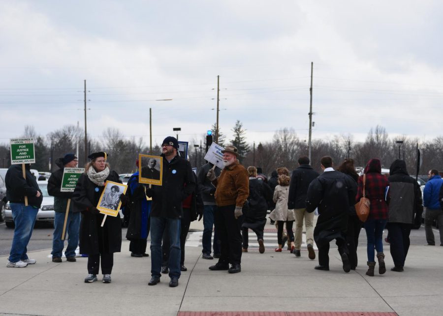 Todd Hawley, center with blue button, along with members of both AAUP_KSU and AFSCME, stands outside the M.A.C. Center picketing after the commencement ceremonies on Sat. Dec. 19, 2015.