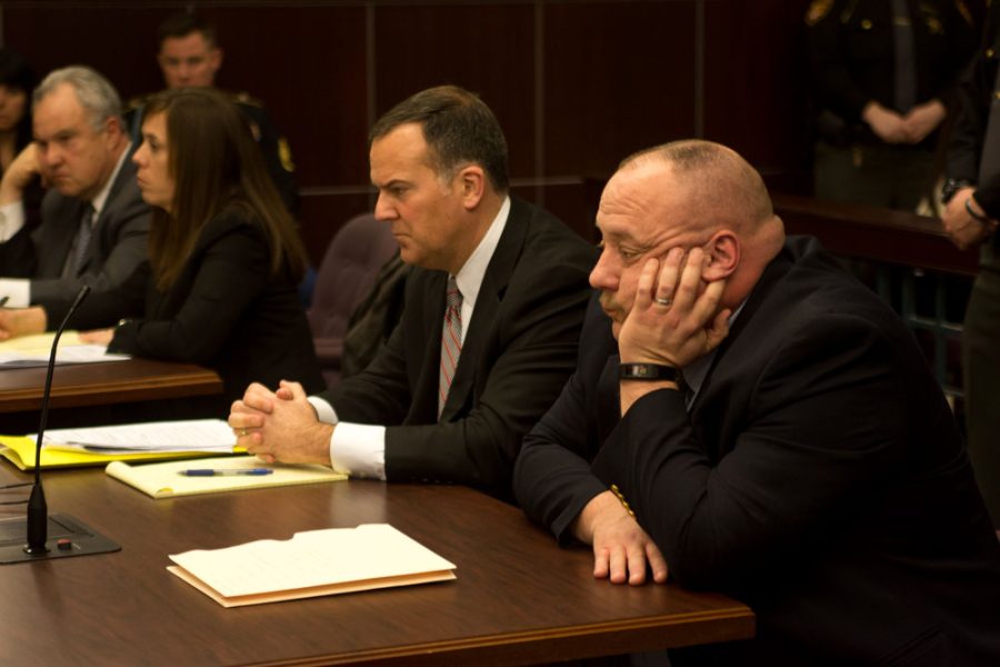 Former Brimfield Police Chief David Oliver (far right) listens to his former subordinate's, Crystal Casterline, testimony against him. Oliver was found guilty of all charges against him. He was sentenced to 600 days in jail as well as $2,304 in fines and restitution. 