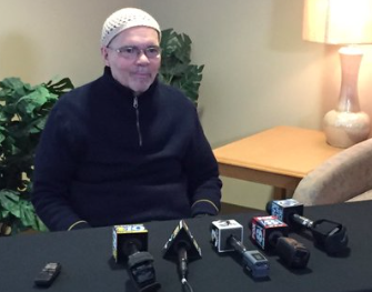 Dr. Julio Pino prepares to speak to the media at Oscar Ritchie Hall. Dr. Pino returned to the classroom Thursday for the first time since the FBI revealed it was investigating the professor for possible ties to the Islamic State.